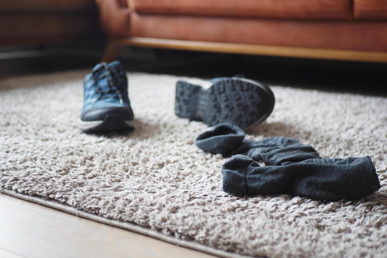 dirty sock and shoe on floor photo