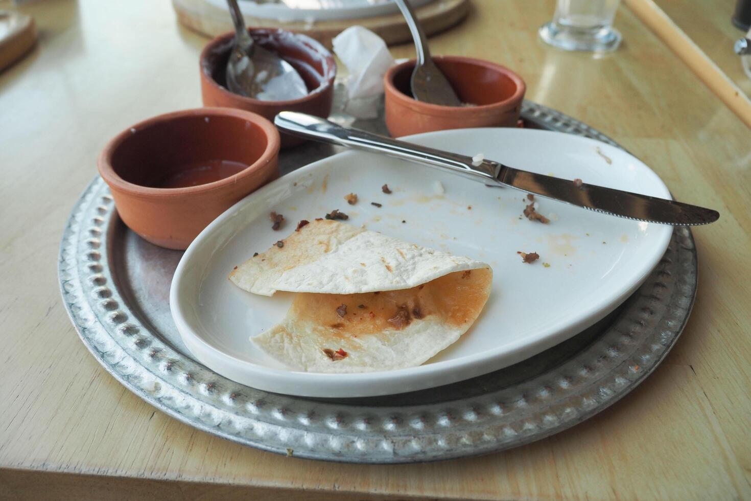 An empty dirty plate with a fork. photo