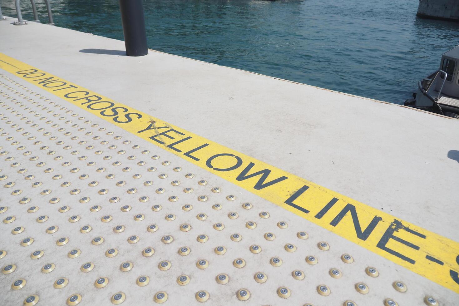 Warning Sign Located on Dock It is Prohibited to Cross the Distinct Yellow Line photo