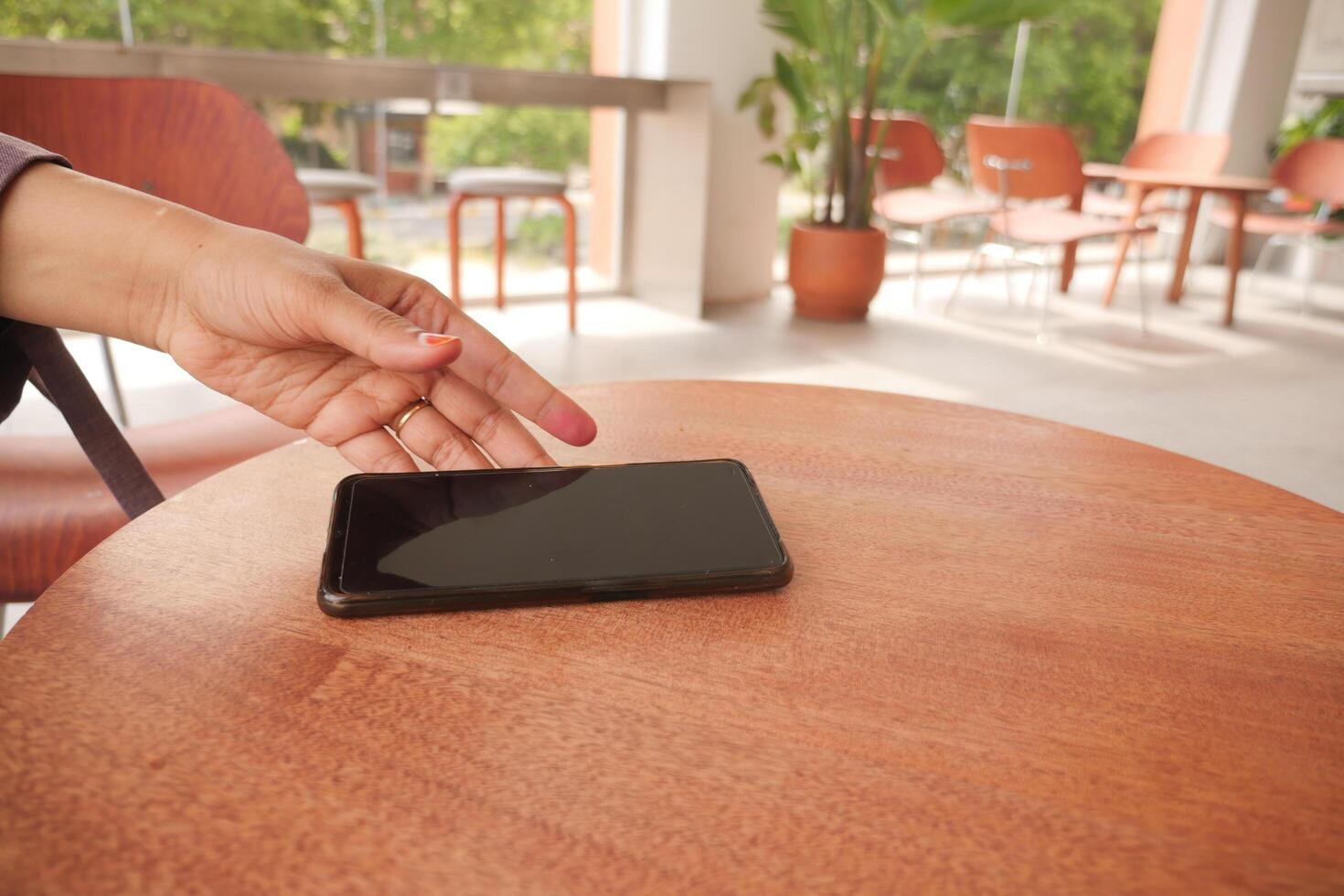 man hand picking up smart phone mobile to receive a call photo