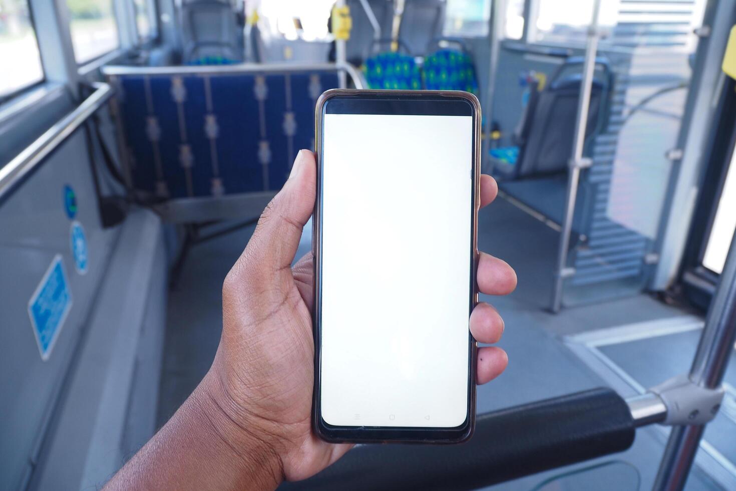 young man hand using smart phone with green screen inside of metro train photo