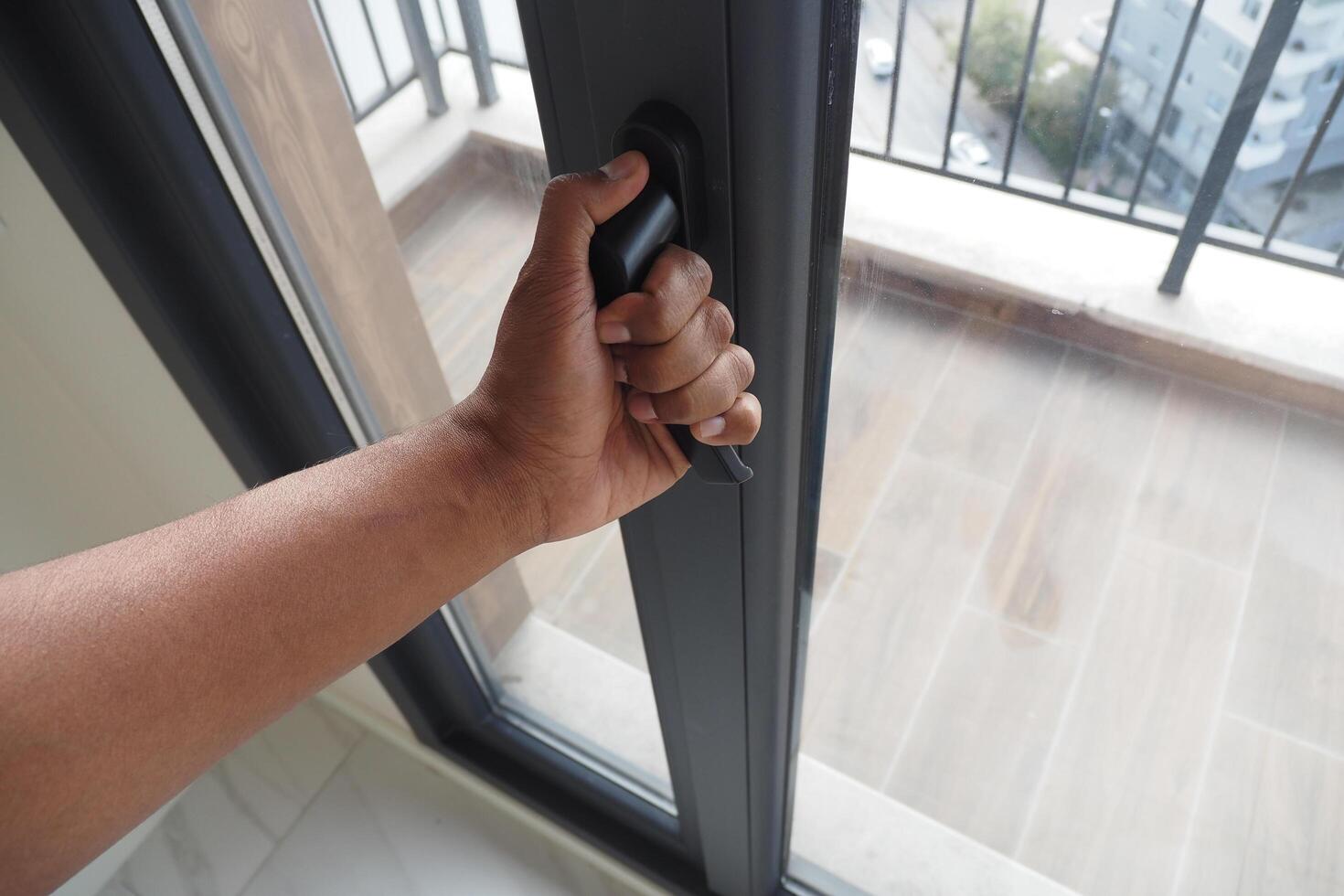 hand open gray plastic pvc window at home at early morning photo