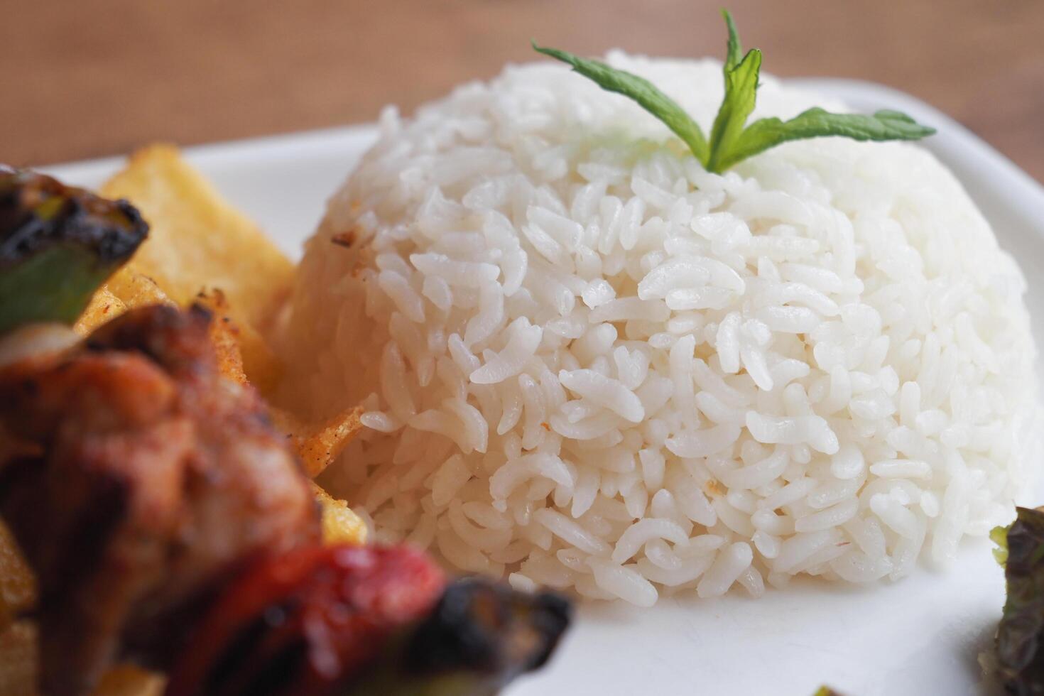 Closeup of a plate featuring white rice, French fries, and a fork, creating a delicious meal photo