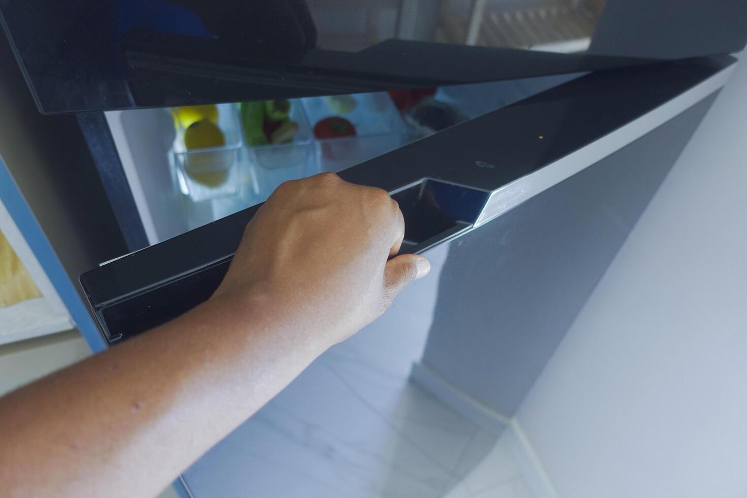 half open fridge with food and vegetables , photo