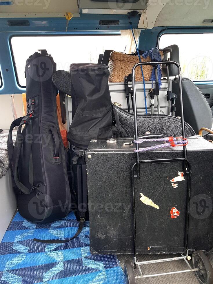 The instruments in the cases are loaded into the van. photo