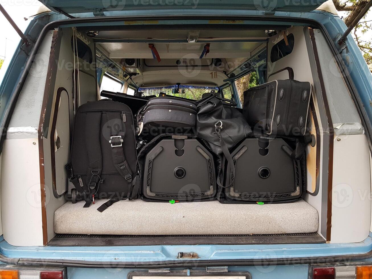 The instruments in the cases are loaded into the van. photo