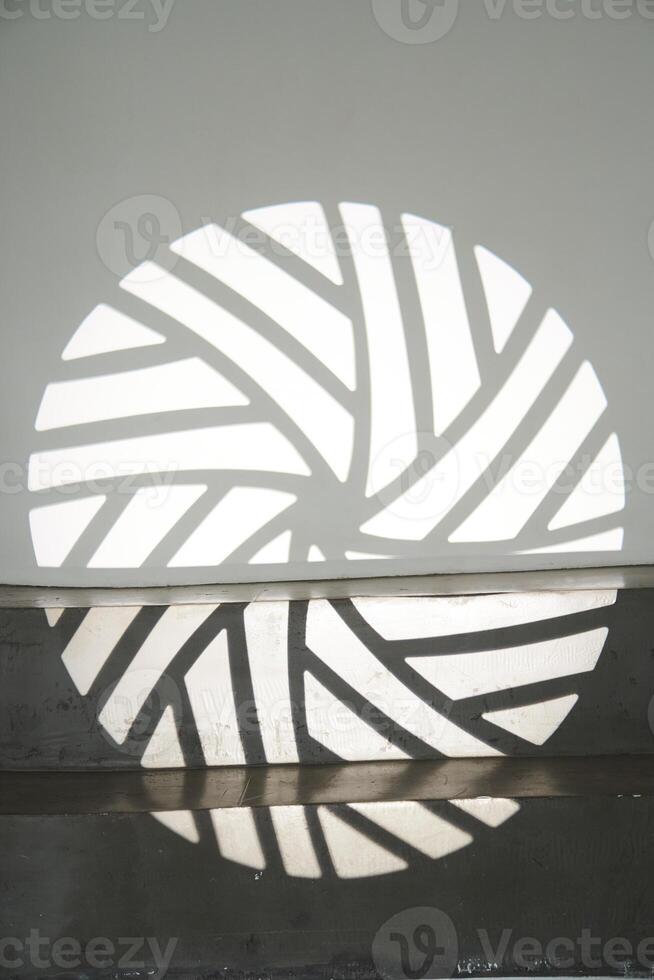 The ledge of the step with a shadow from the light pattern. The silhouette of the gobo mask on the wall surface with space to copy. photo