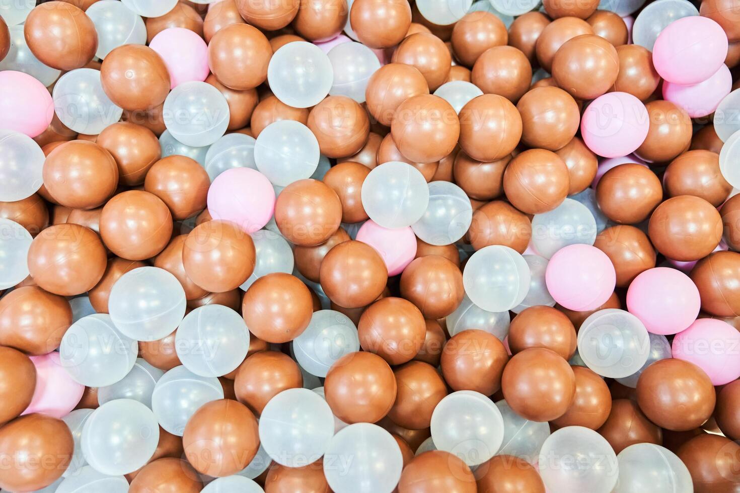 A children's party, a playroom, a box filled with small colored balls. Colored plastic balls in the pool of the playroom in close-up. With space to copy photo