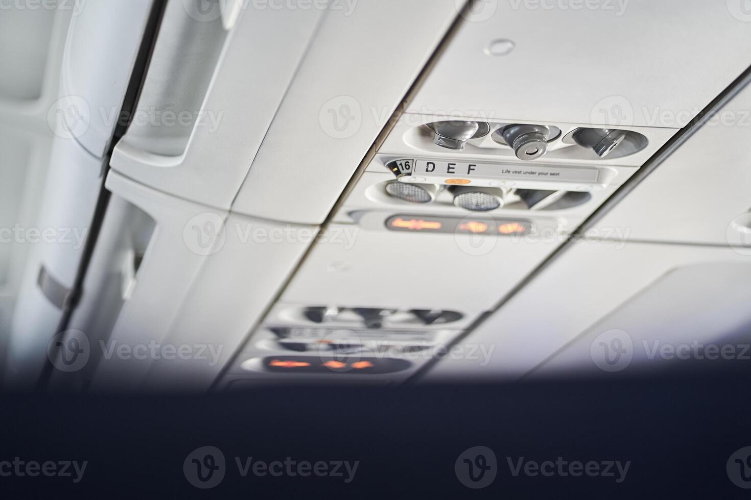 The buttons are located on the ceiling of a passenger aircraft, where safety elements such as an oxygen mask are located. With space to copy photo