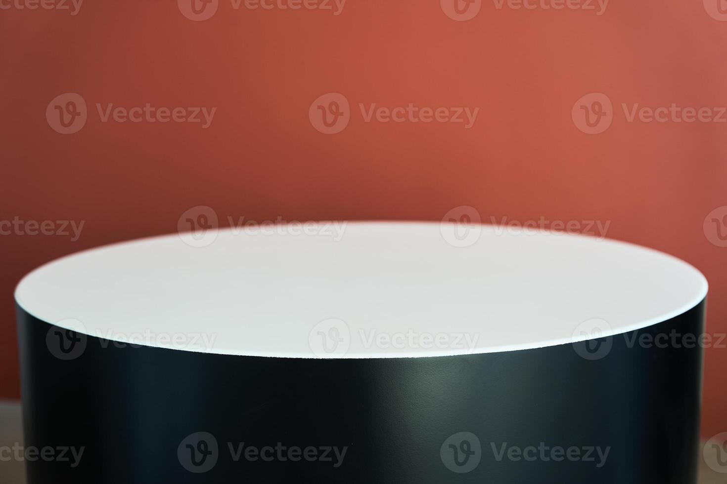White and black round podium template on the red wall. Empty product display for your advertising presentation. Front view. Copy space. photo