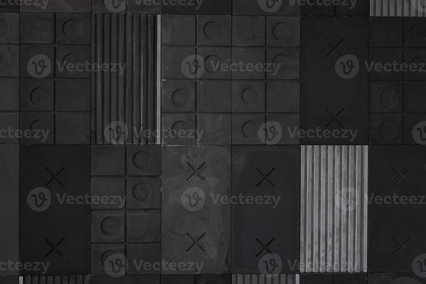 Textured black, gray geometric background made of concrete with stripes, squares, circles, crosses, tic-tac-toe, copy space. Concept of modern abstract creative wall design with bulky convex elements photo