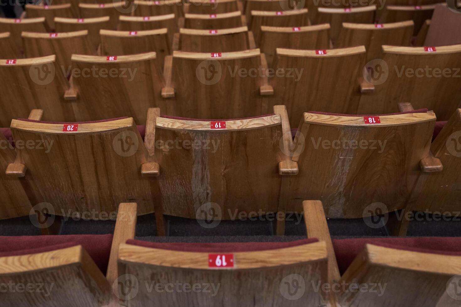 Chairs in a row for the audience. Rear view. The concept of the cultural environment. Wooden and symmetrical . Empty seats. photo