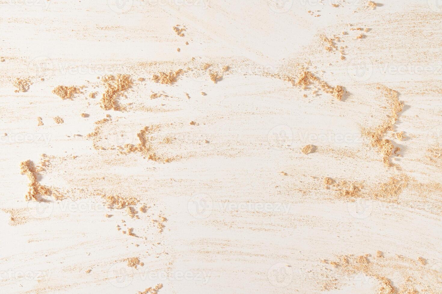 A neutral-colored face powder smeared on the surface, on a light background. Top view, flat position. Copy the location for your text. Powder texture photo