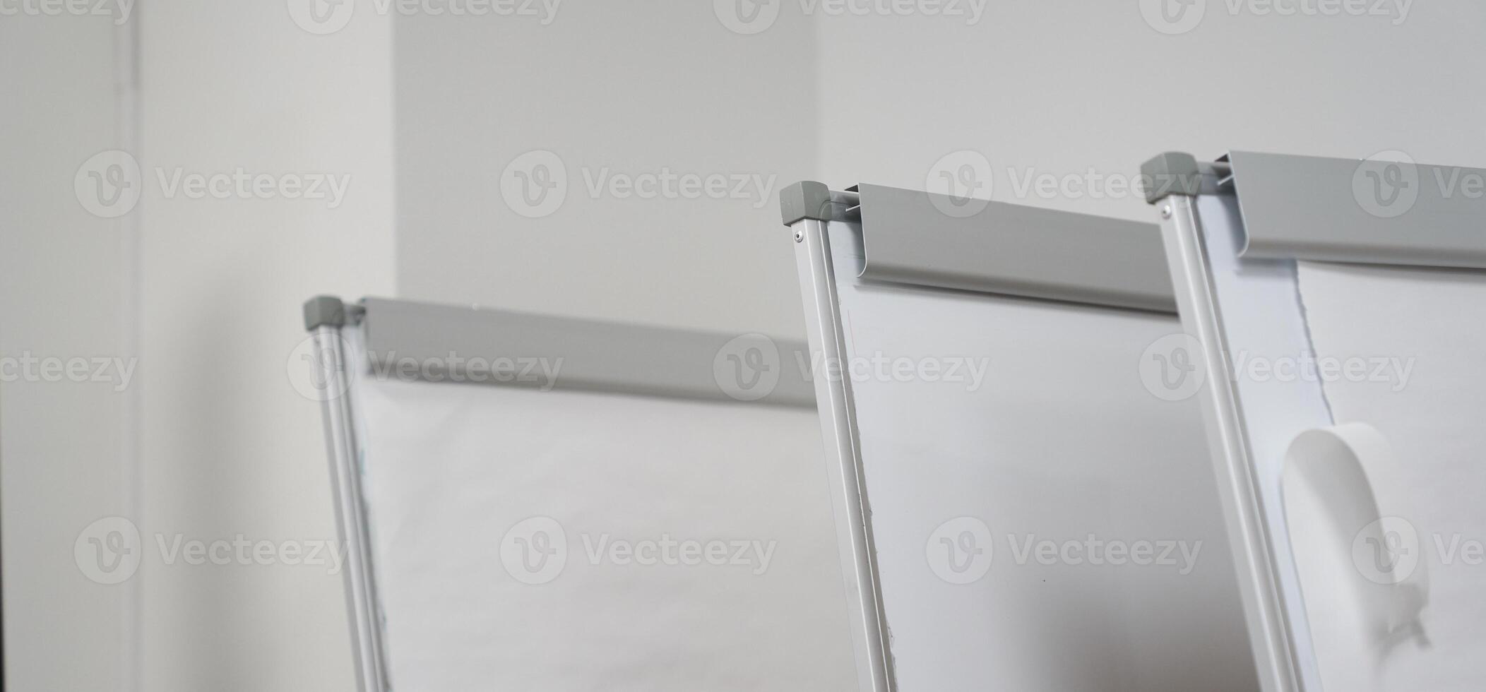 A banner from a row of clean white boards for a business presentation at the stand. Office whiteboard for business training in the office. The concept of the training and seminar. photo