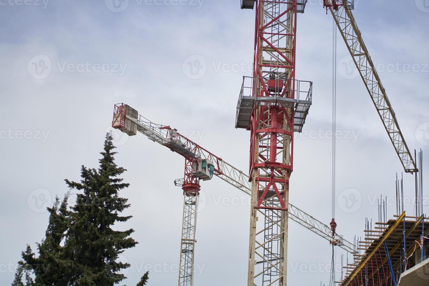 A working tower crane on large construction sites, and many cranes working in the field of new construction. Construction of an apartment building photo