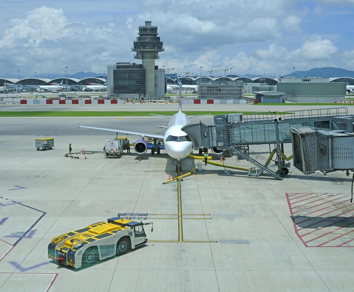 Airport terminal huge glass window with front view of air plane and air traffic control tower photo