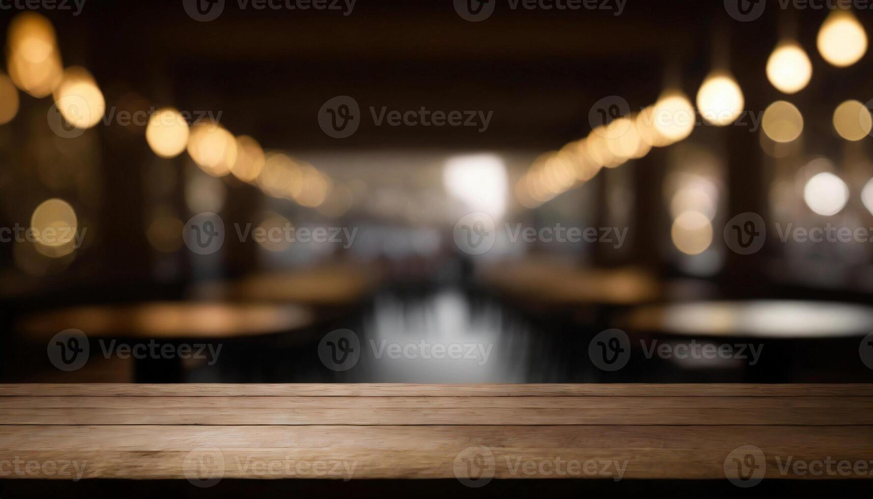 Empty wooden table in front of blurred bokeh background of restaurant. For display or montage products photo