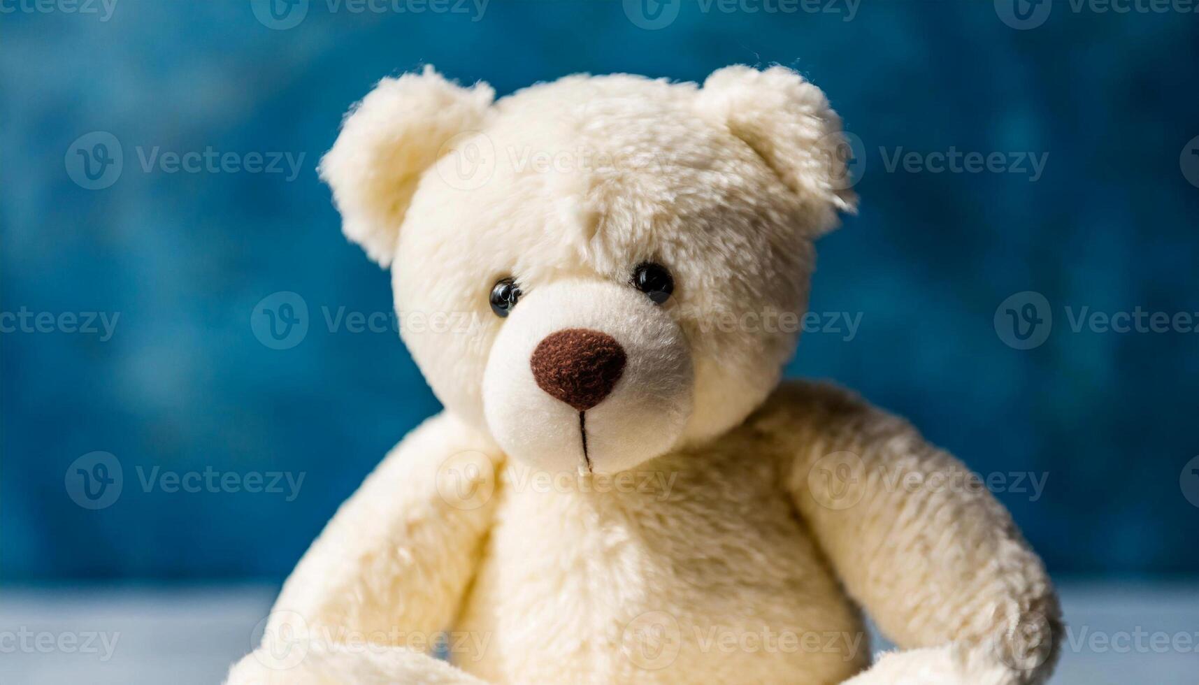 Beautiful teddy bear, plush toy against bright blue backdrop. photo