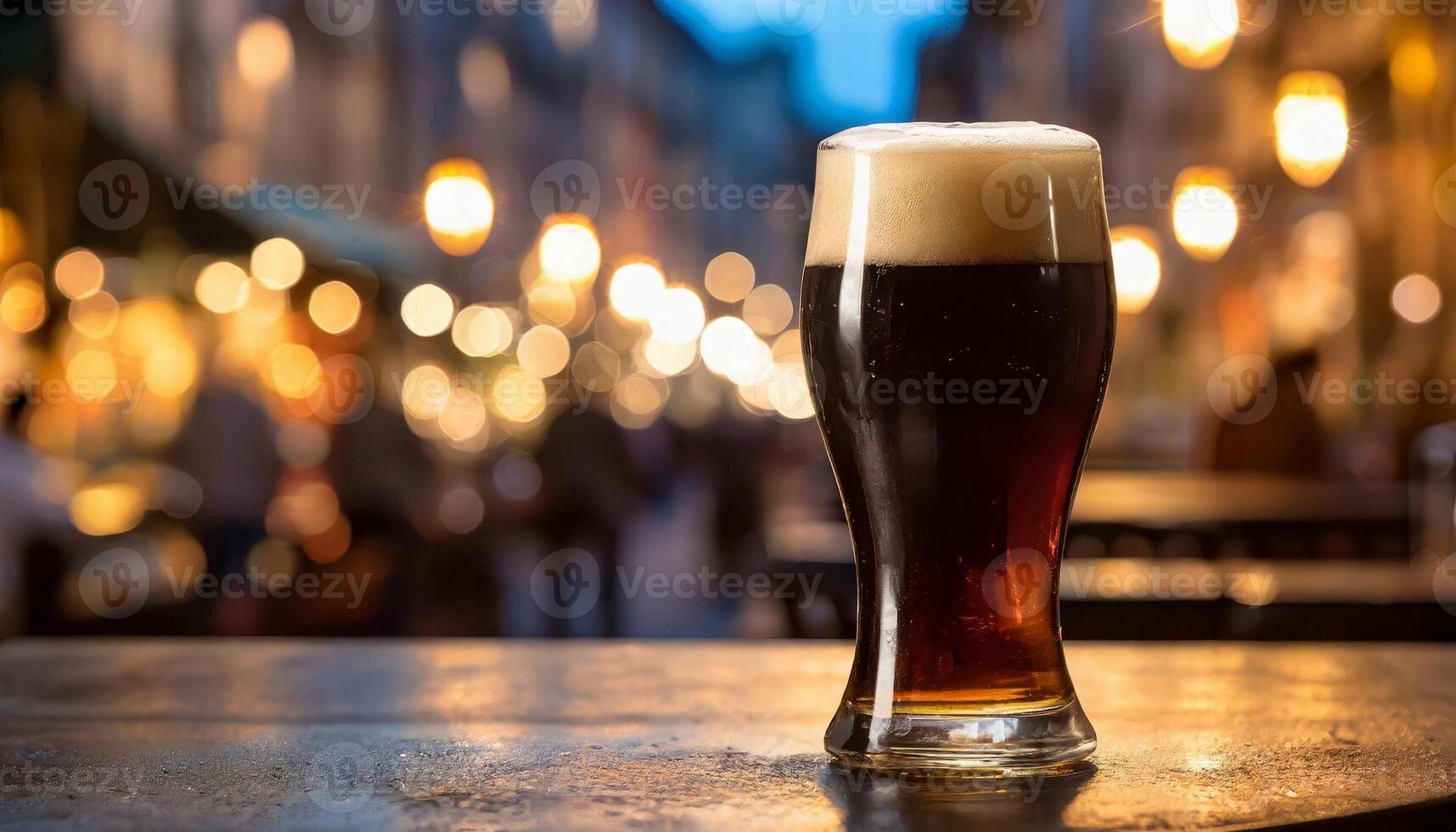 Glass of dark beer at night in pub on wooden table. Alcoholic drink photo