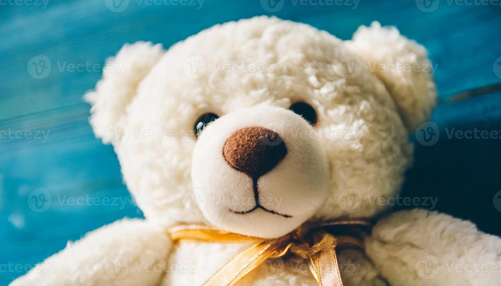 Beautiful teddy bear, plush toy against bright blue backdrop. photo