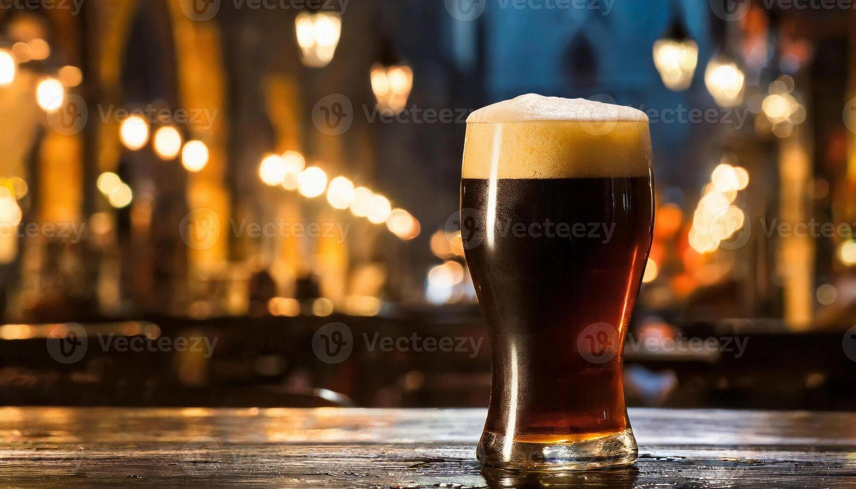 Glass of dark beer at night in pub on wooden table. Alcoholic drink photo