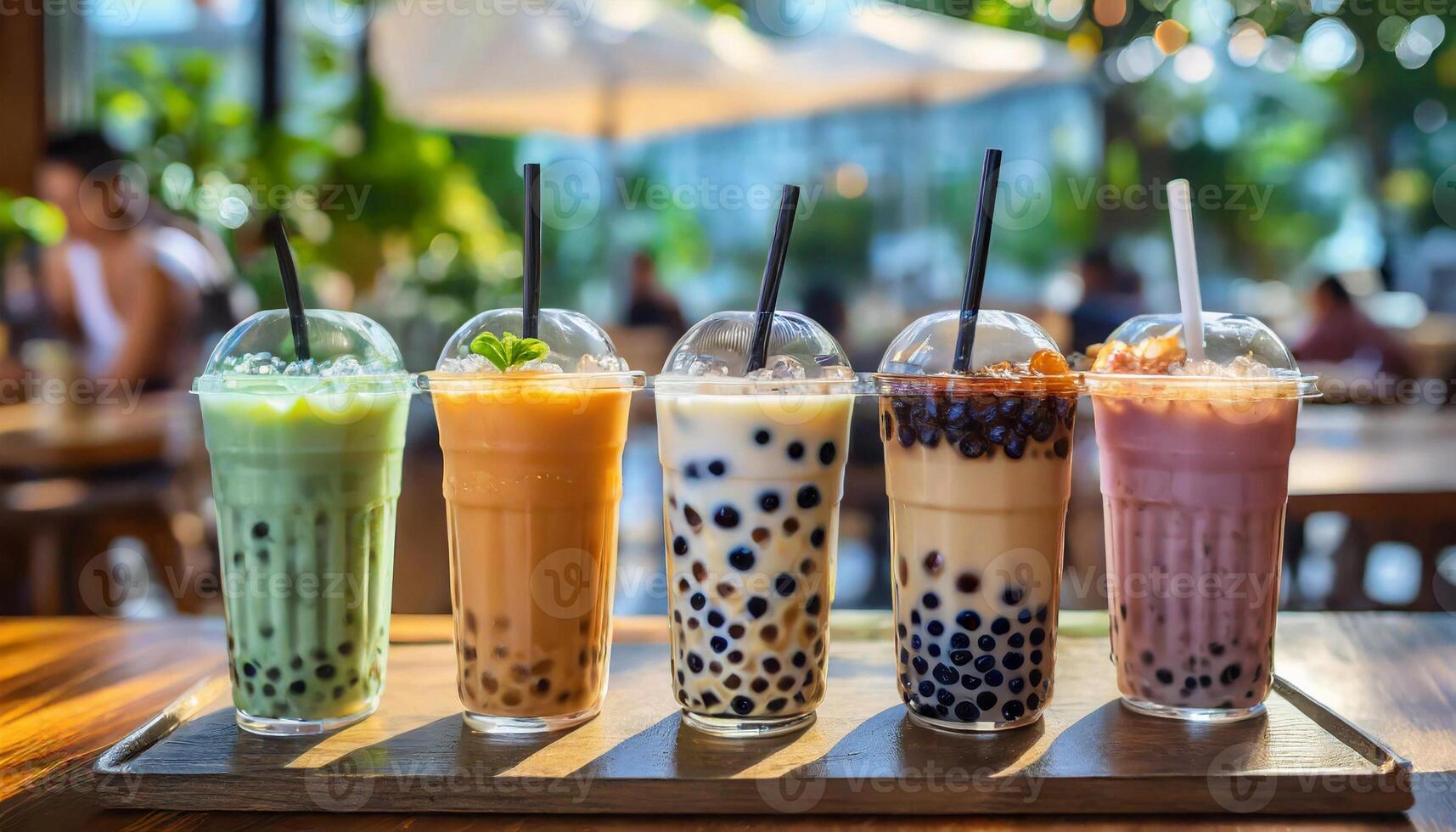 Variety of boba bubble tea with straws on table in cafe. photo