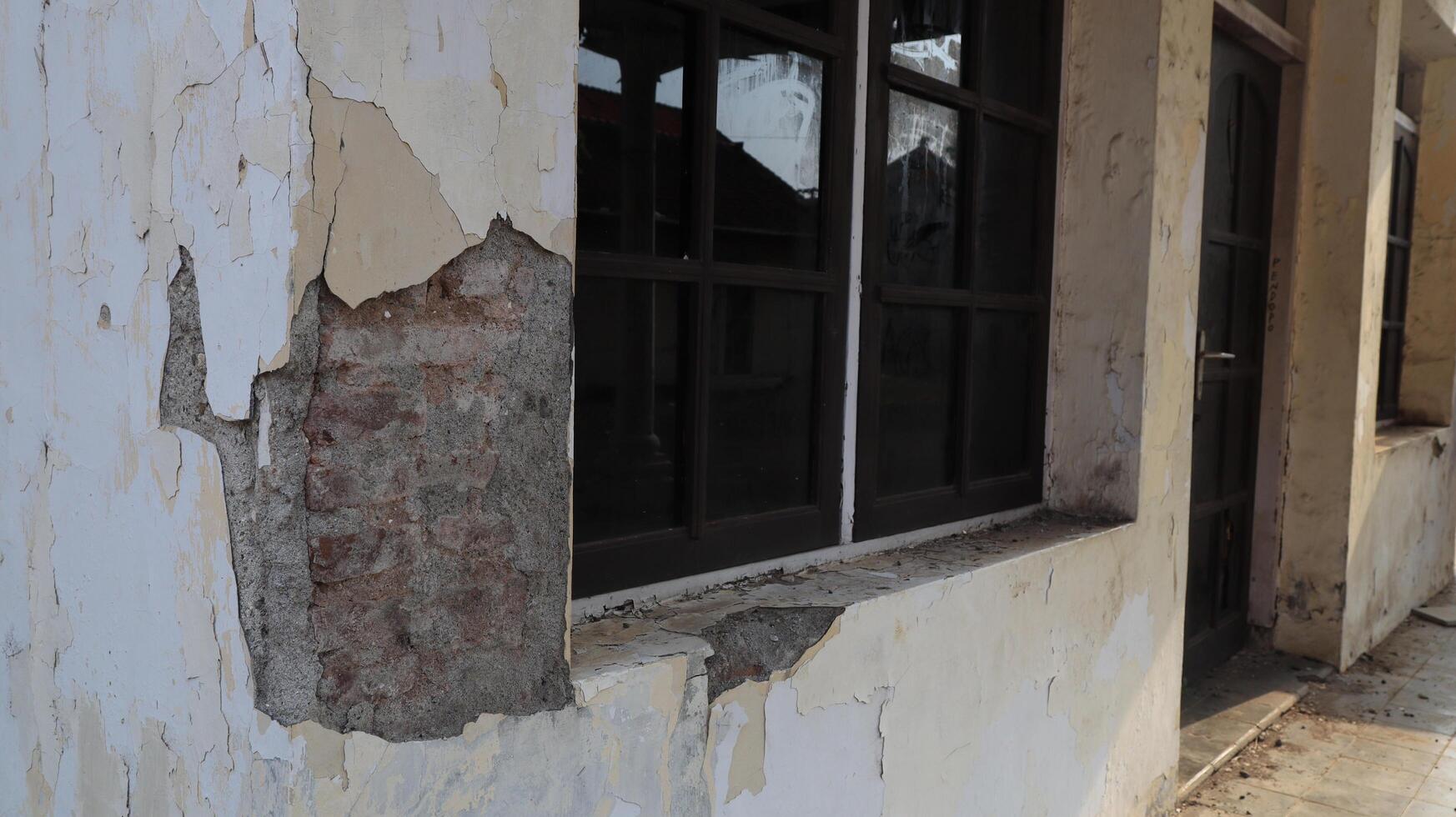 Old house, facade of a building ruin in old town photo