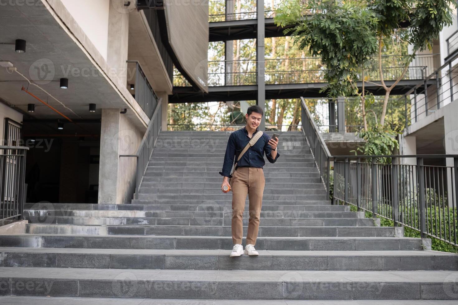 Young Office Worker Enjoying a Productive Day Working Outside in a Modern Urban Environment photo