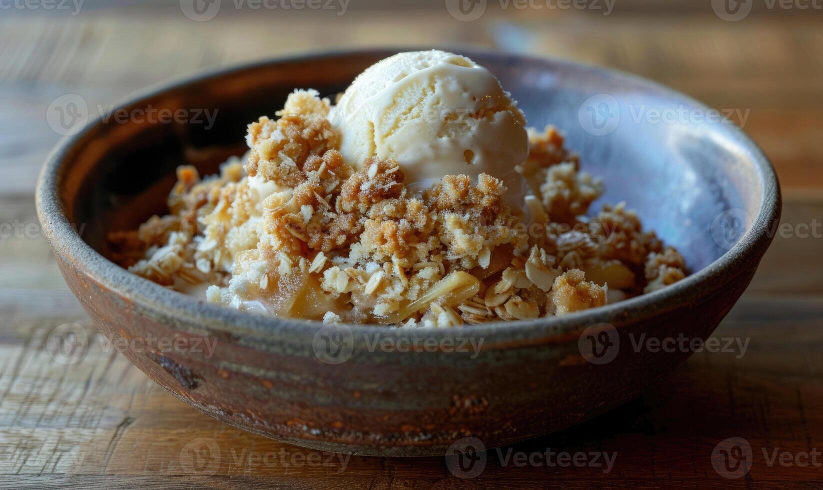 Apple crumble with a scoop of vanilla ice cream in a rustic bowl photo