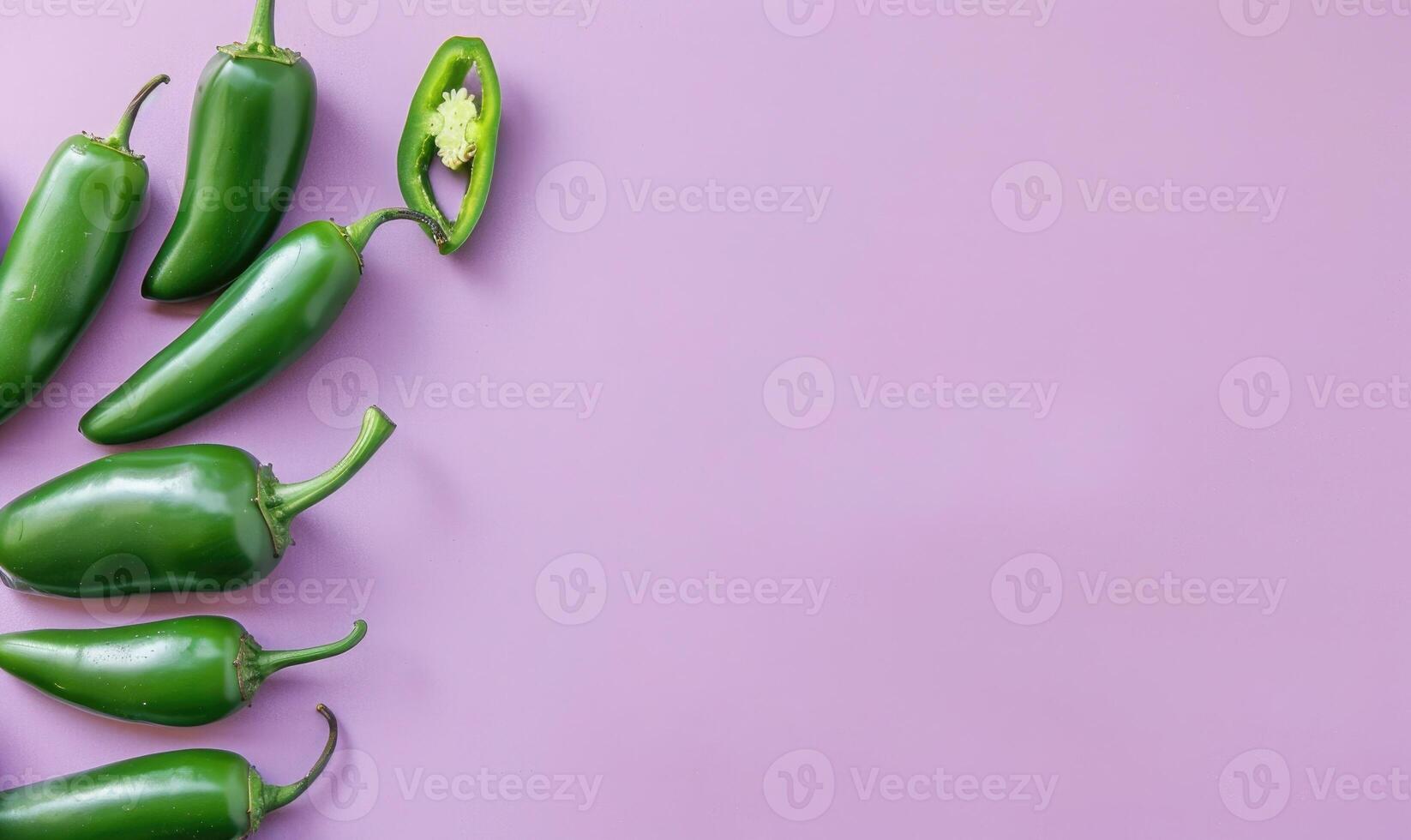 Top view of a jalapeno peppers arranged on a pastel purple background photo