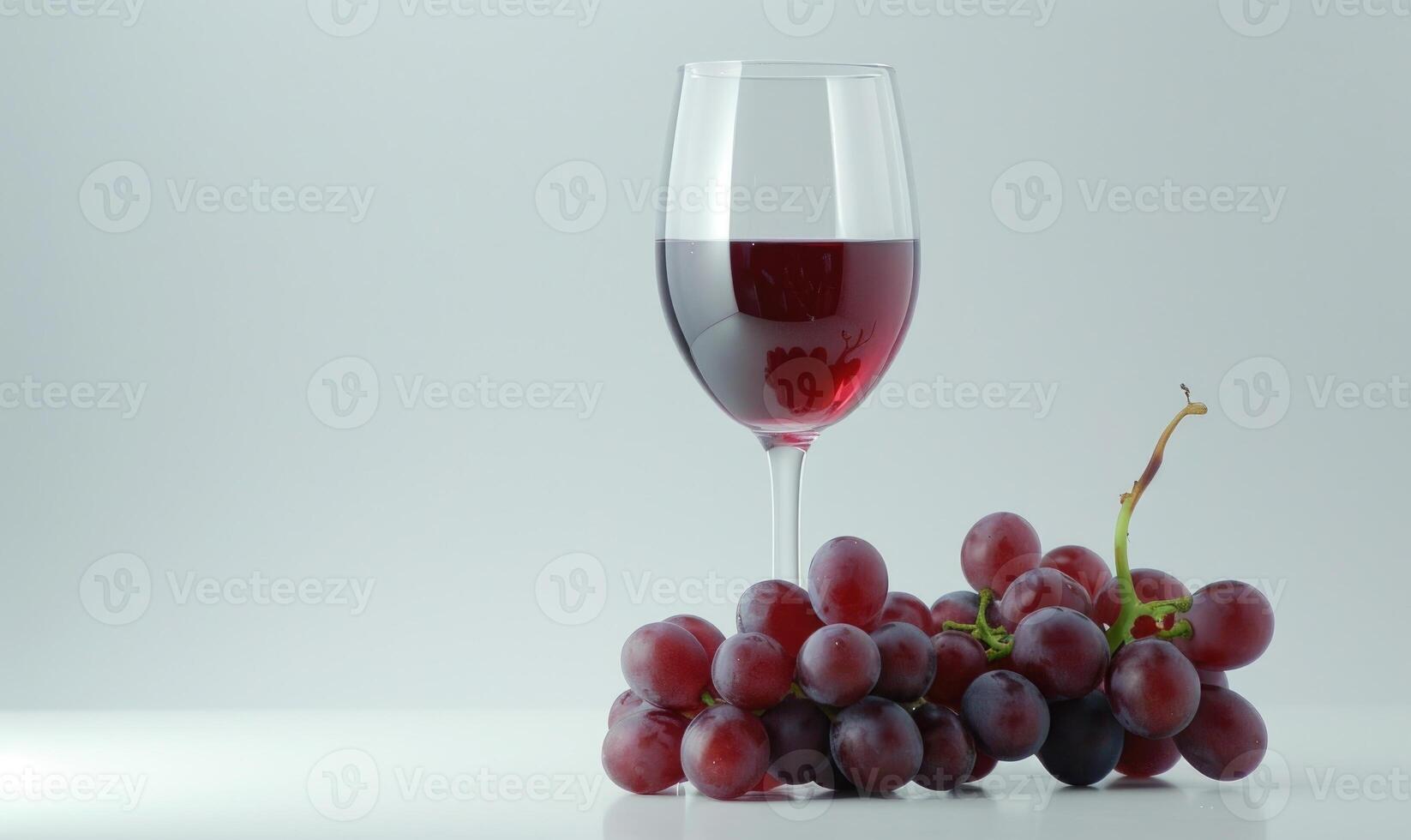 Grapes on a simple white background with a glass of red wine photo