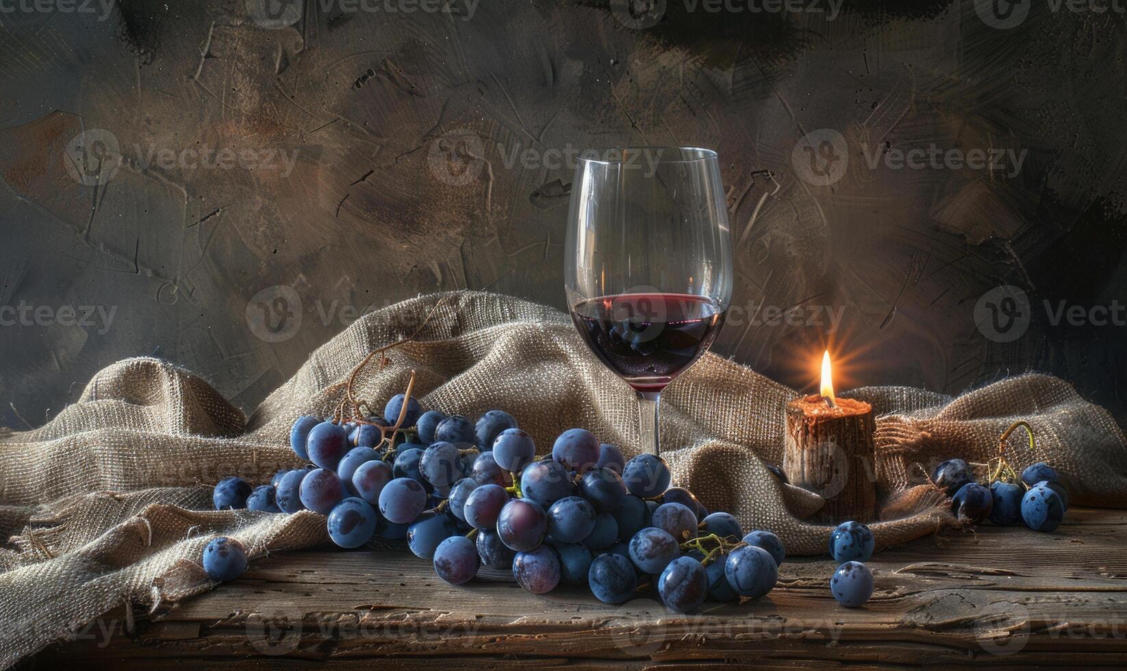 Grapes on a rustic burlap cloth with a glass of red wine photo