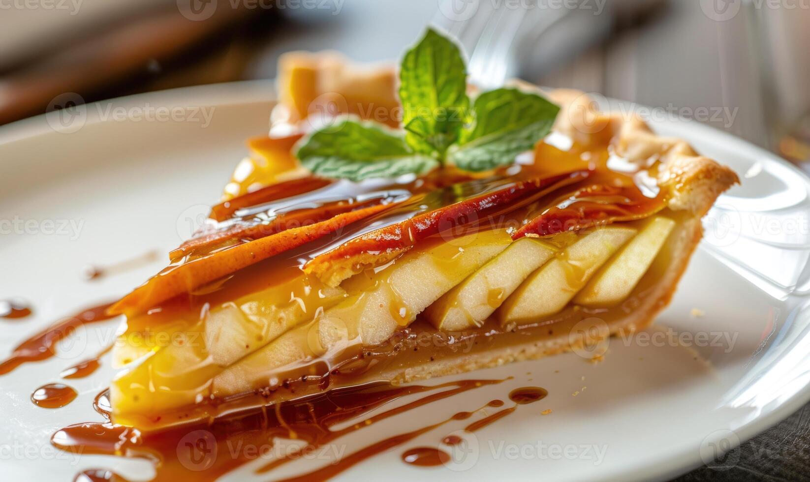 Slice of apple tart topped with caramel sauce photo