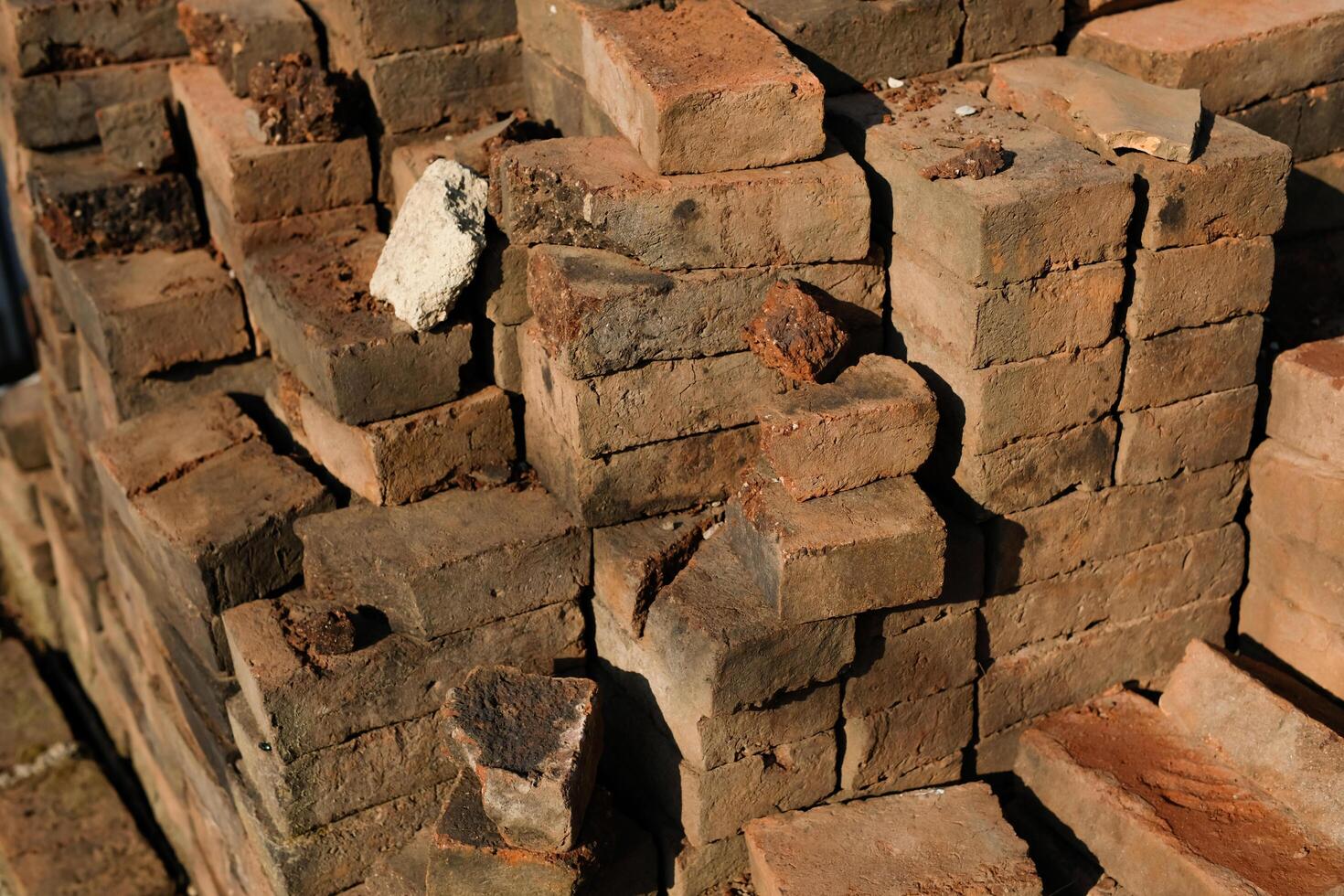 Textured Detail of mossy bricks on the side of the road. Photograph of piles of used bricks left over from house construction. Abstract Background. Construction Industry. Background Photgraphy. photo