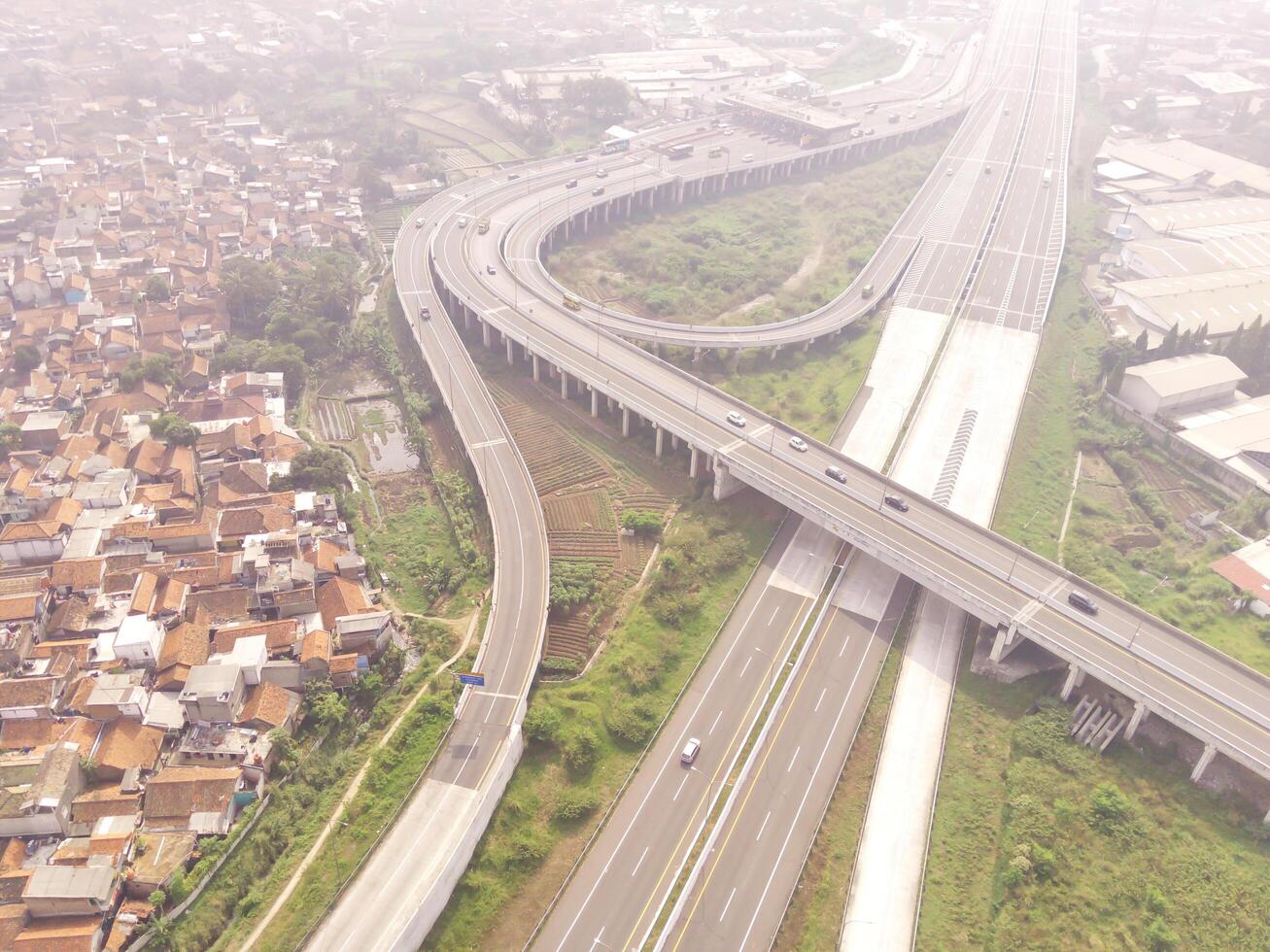 Bird eye view of Multiple vehicle lanes on Purbaleunyi Toll, Indonesia. Transportation Industry. Panoramic Landscape. Graphic Resources. Drones Point of view. Aerial Landscape Photography Concept photo