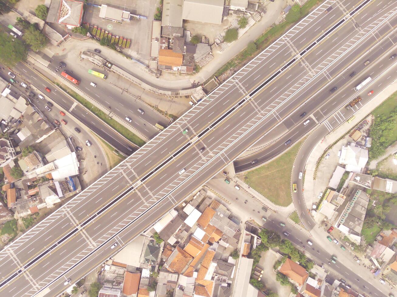Bird eye view of Multiple vehicle lanes on Purbaleunyi Toll, Indonesia. Transportation Industry. Panoramic Landscape. Graphic Resources. Drones Point of view. Aerial Landscape Photography Concept photo