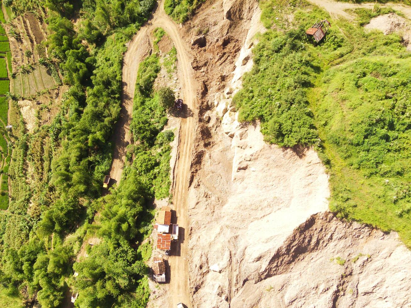 Aerial shot of Mount Padakasih slopes damaged by sand mining. Mining Industry. Panoramic Landscape. Graphic Resources. Selective Focus. Aerial Landscape Photography Concept photo