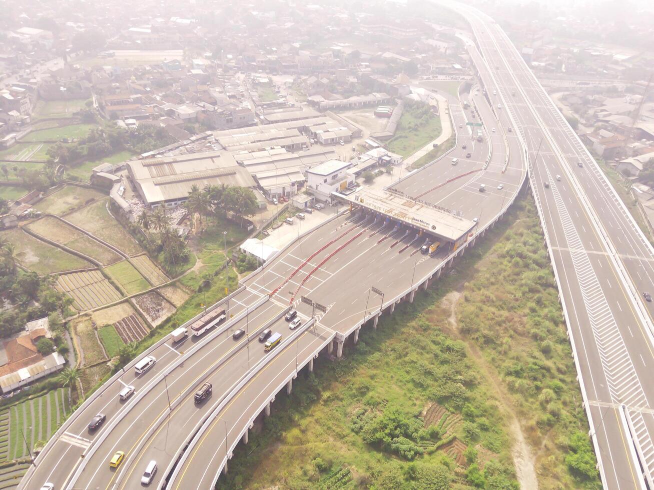 Bird eye view of Multiple vehicle lanes on Purbaleunyi Toll, Indonesia. Transportation Industry. Panoramic Landscape. Graphic Resources. Drones Point of view. Aerial Landscape Photography Concept photo
