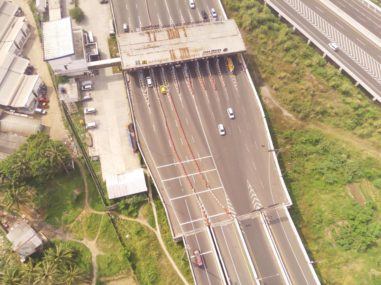 Bird eye view of Multiple vehicle lanes on Purbaleunyi Toll, Indonesia. Transportation Industry. Panoramic Landscape. Graphic Resources. Drones Point of view. Aerial Landscape Photography Concept photo