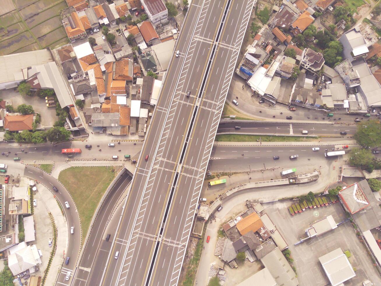 Bird eye view of Multiple vehicle lanes on Purbaleunyi Toll, Indonesia. Transportation Industry. Panoramic Landscape. Graphic Resources. Drones Point of view. Aerial Landscape Photography Concept photo