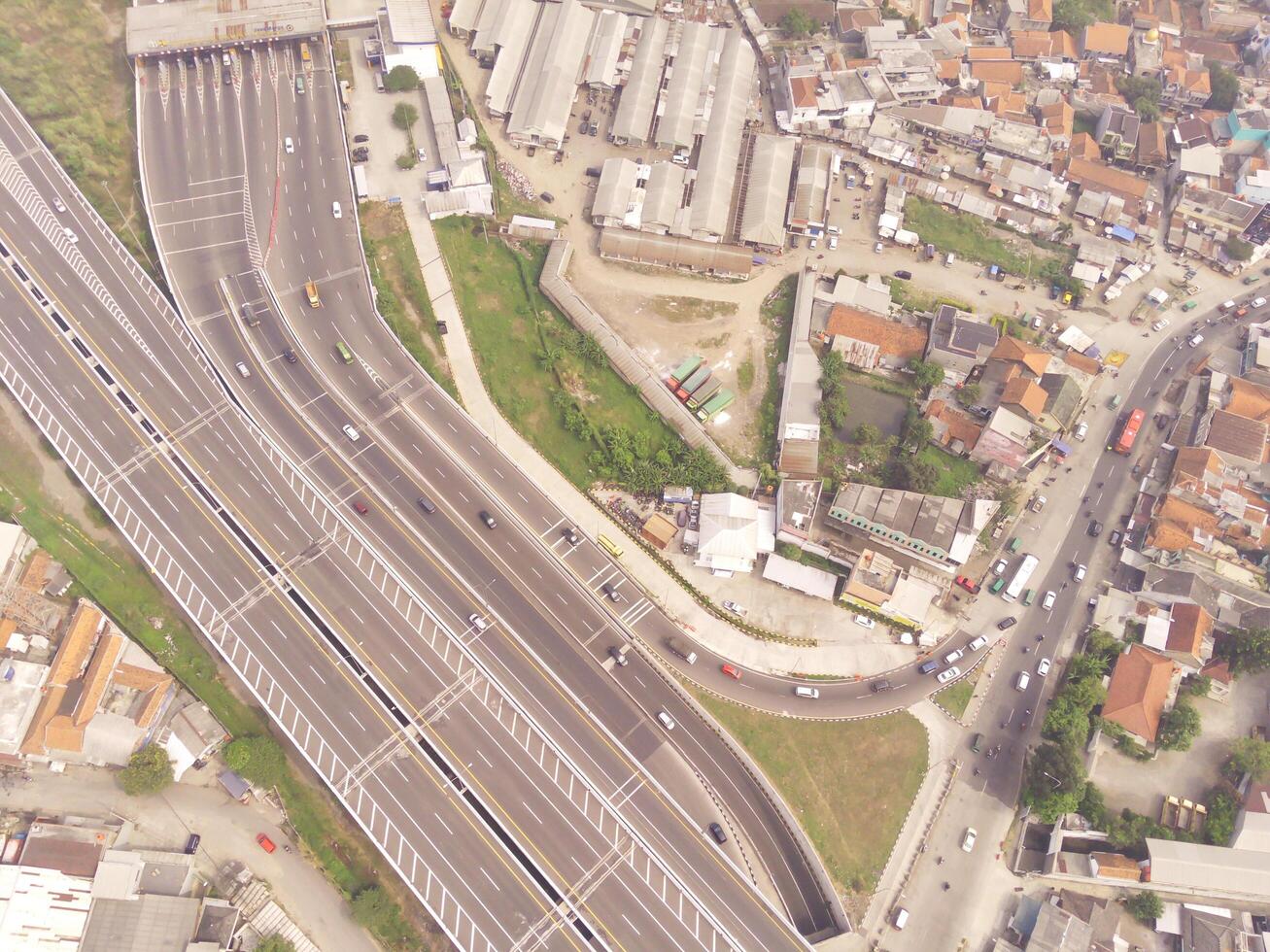 Bird eye view of Multiple vehicle lanes on Purbaleunyi Toll, Indonesia. Transportation Industry. Panoramic Landscape. Graphic Resources. Drones Point of view. Aerial Landscape Photography Concept photo