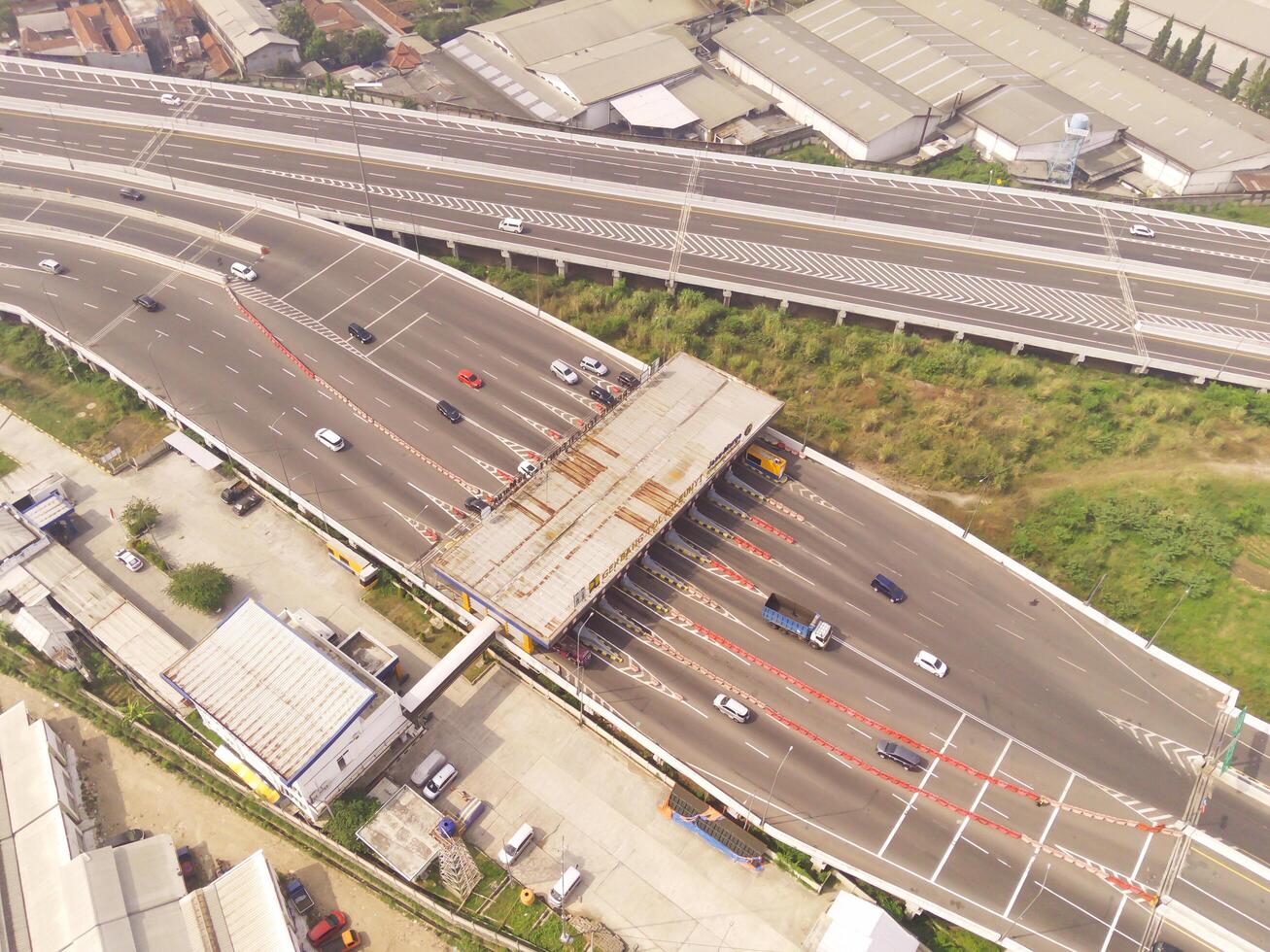 Bird eye view of Multiple vehicle lanes on Purbaleunyi Toll, Indonesia. Transportation Industry. Panoramic Landscape. Graphic Resources. Drones Point of view. Aerial Landscape Photography Concept photo