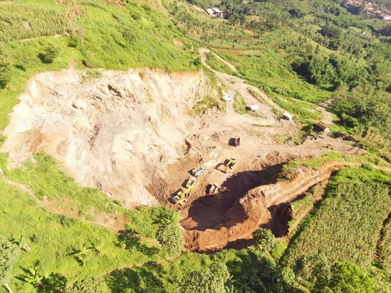 Aerial shot of Mount Padakasih slopes damaged by sand mining. Mining Industry. Panoramic Landscape. Graphic Resources. Selective Focus. Aerial Landscape Photography Concept photo