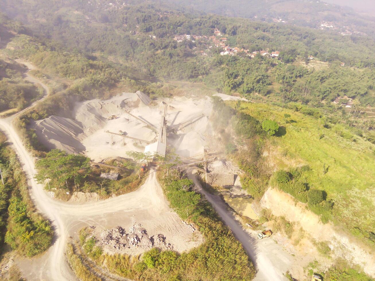 Aerial shot of Mount Padakasih slopes damaged by sand mining. Mining Industry. Panoramic Landscape. Graphic Resources. Selective Focus. Aerial Landscape Photography Concept photo