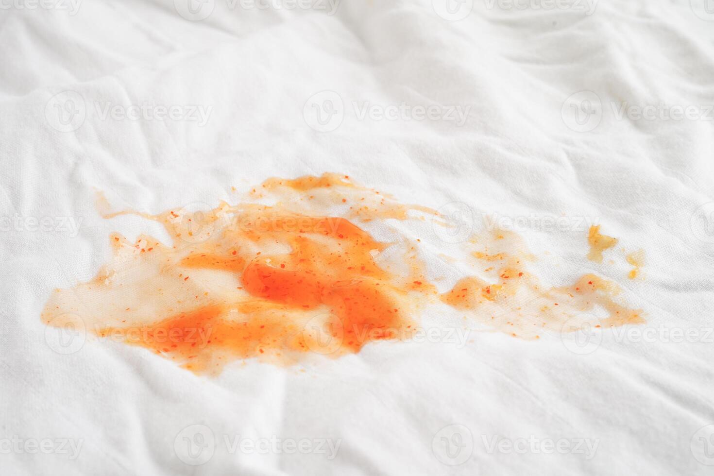 Dirty spicy sauce stain on cloth to wash with washing powder, cleaning housework concept. photo