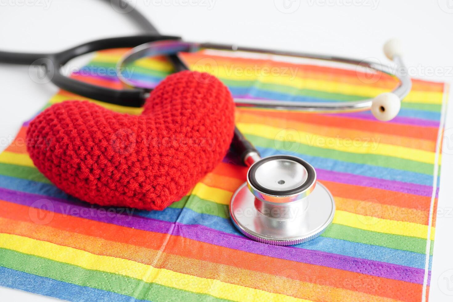 LGBT symbol, Stethoscope with red heart on rainbow flag, rights and gender equality, LGBT Pride Month in June. photo