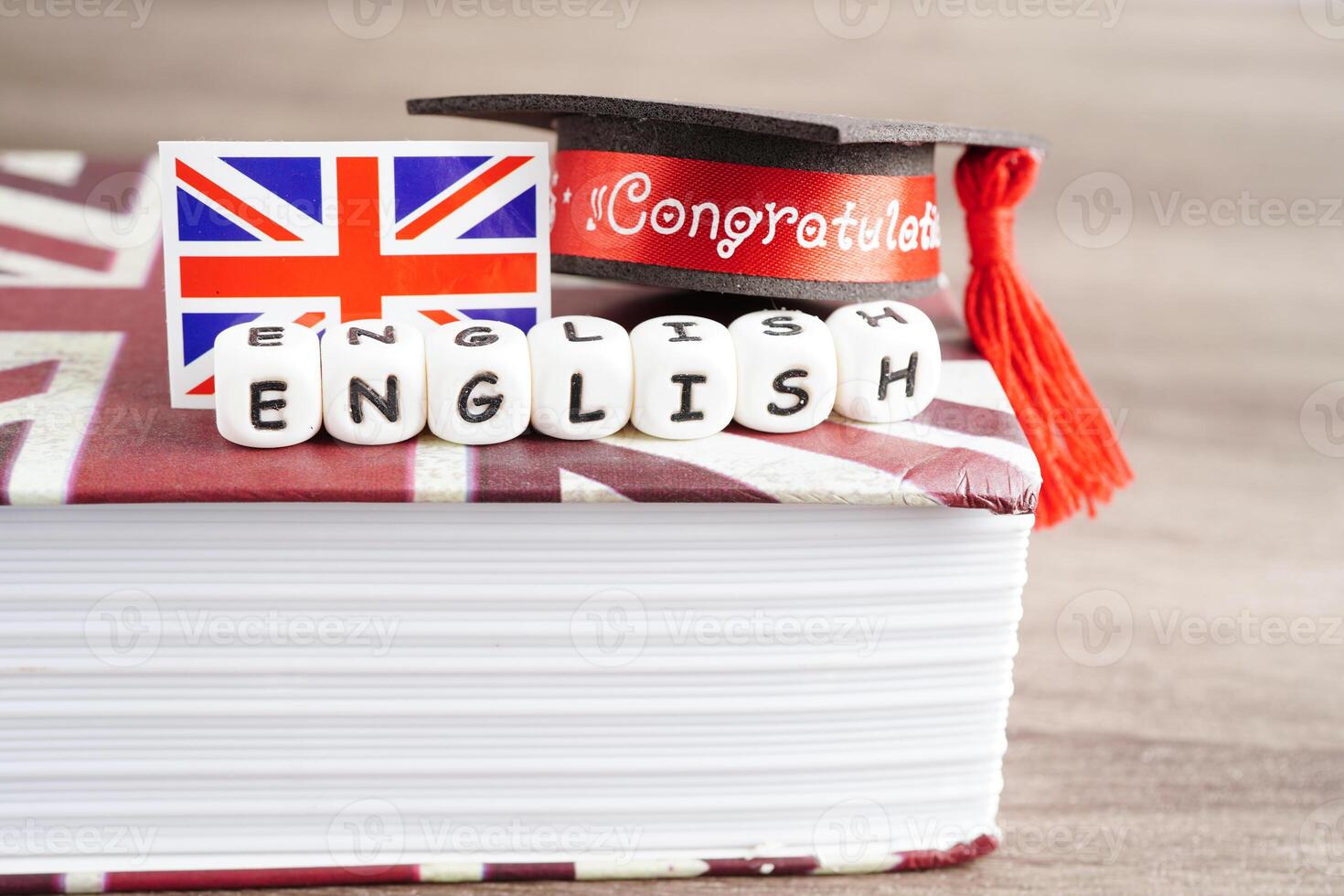 English book with graduate hat, learning and tutorial for foreigner photo