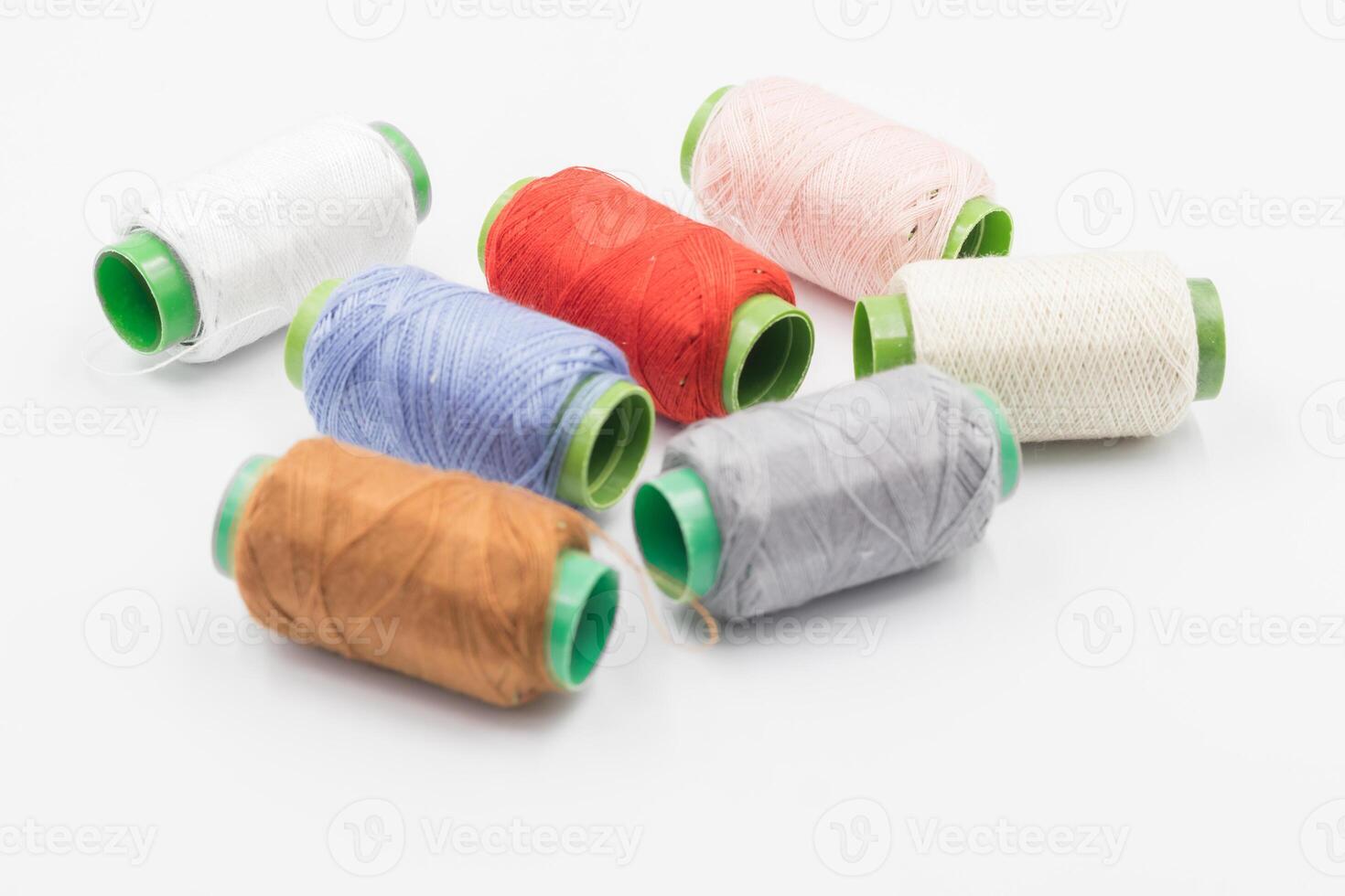 Colorful Spool of sewing thread, spool of industrial threads, Colored spools of thread on a white background. photo