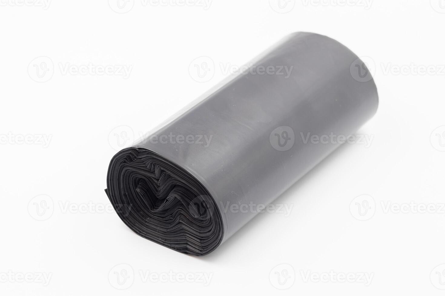 Black plastic garbage bags on white background, Roll of garbage bags on white background photo