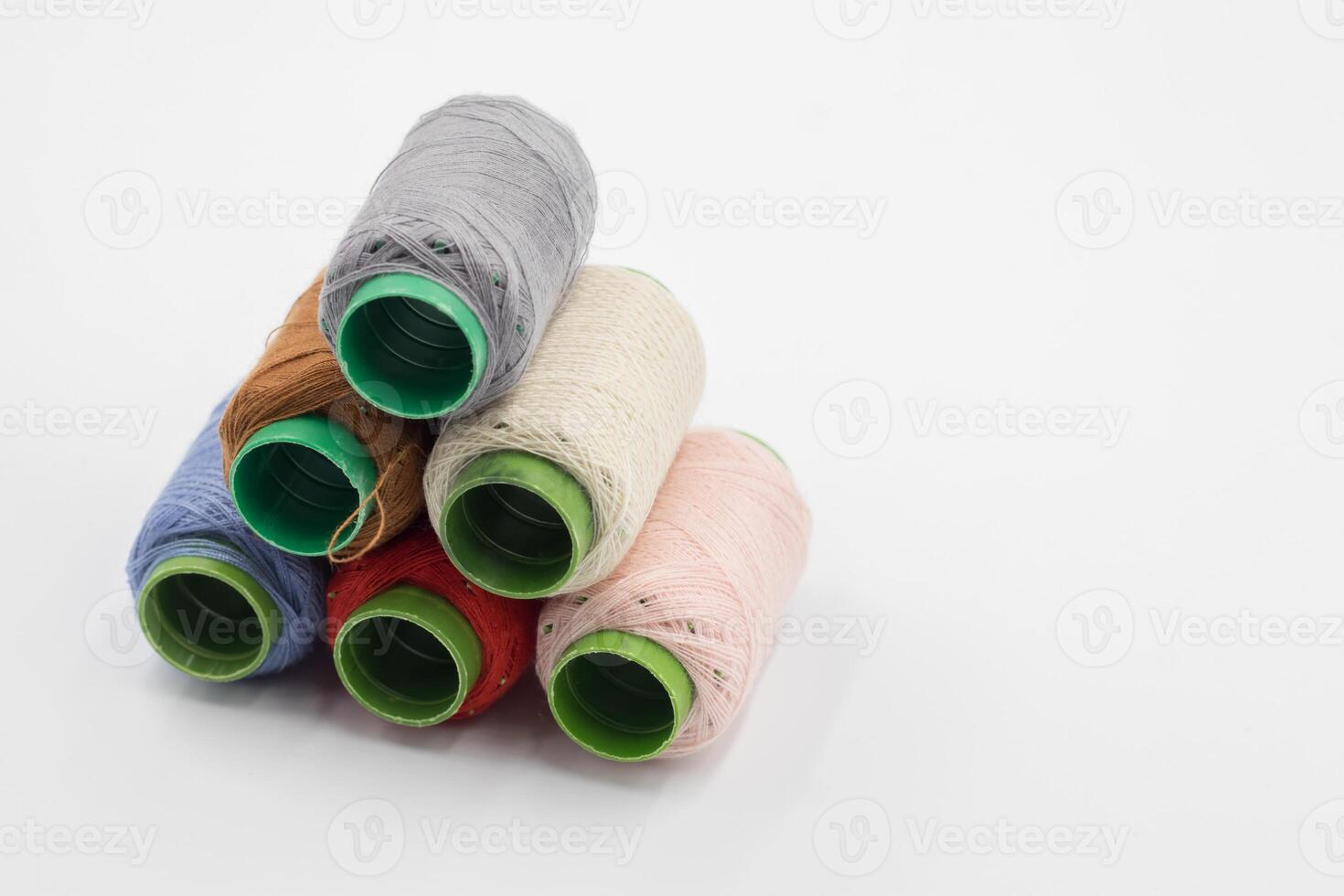 Colorful Spool of sewing thread, spool of industrial threads, Colored spools of thread on a white background. photo